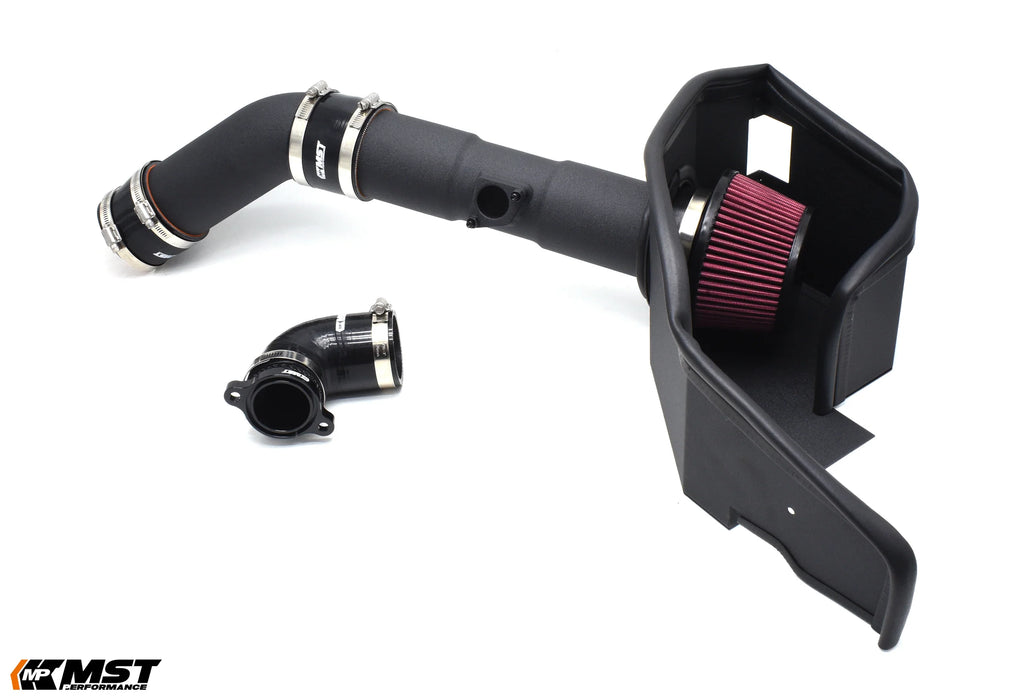 An automotive air intake system featuring a black plastic housing, red air filter, and connecting hoses for improved engine performance.
